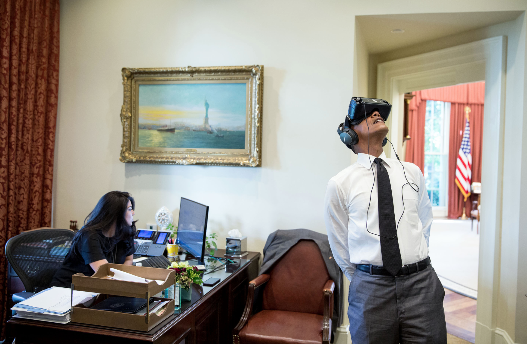 President Barack Obama watches a virtual reality film captured during his trip to Yosemite National Park earlier this year, in the Outer Oval Office, Aug. 24, 2016. Personal aide Ferial Govashiri sits at her desk at left. (Official White House Photo by Pete Souza)
